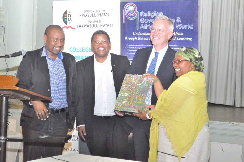 Dr Chad Berry is presented with a token of appreciation by the JL Dube Organising Committee