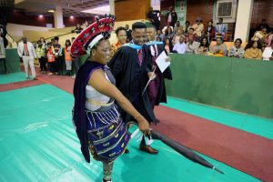A parent celebrates her son graduating with a degree in Education
