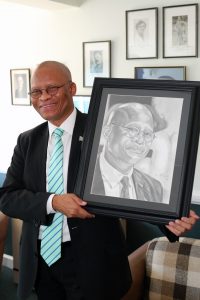Chancellor Chief Justice Mogoeng Mogoeng is thrilled to recieve a framed sketching of himself