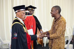 Chancellor Chief Justice Mogoeng Mogoeng shares a light hearted greeting with Protas Madlada
